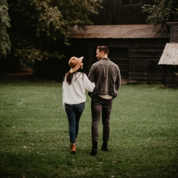 Couple close together on the grass