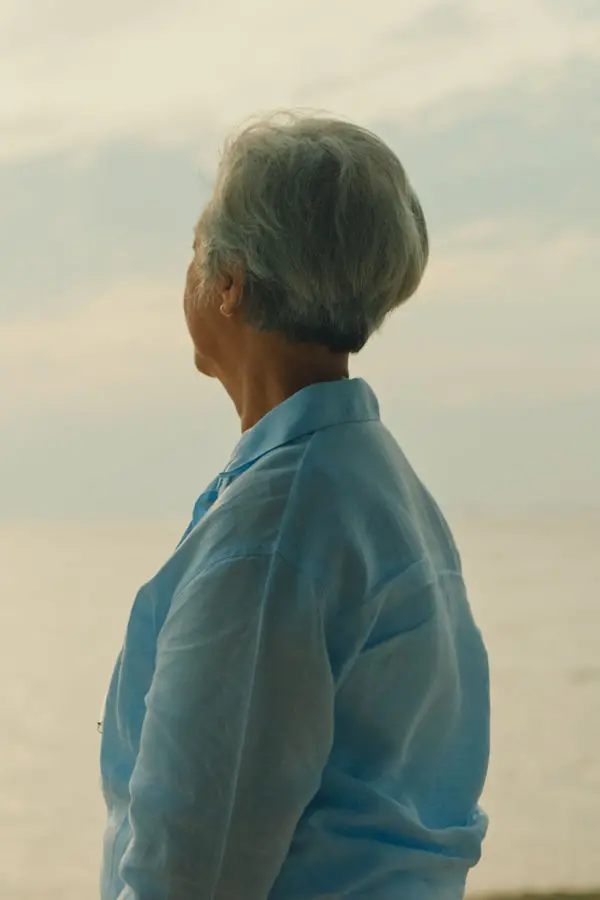 Woman in looking away at the beach