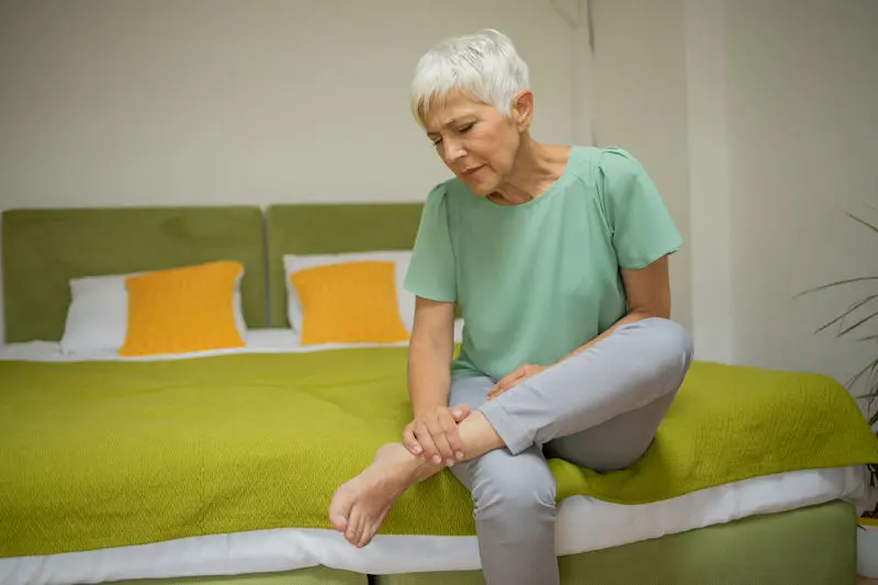 Woman holding her foot